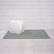 Chilewich striped woven mat with textured terrastrand yarn surface, featuring modern linear design and durable finish.