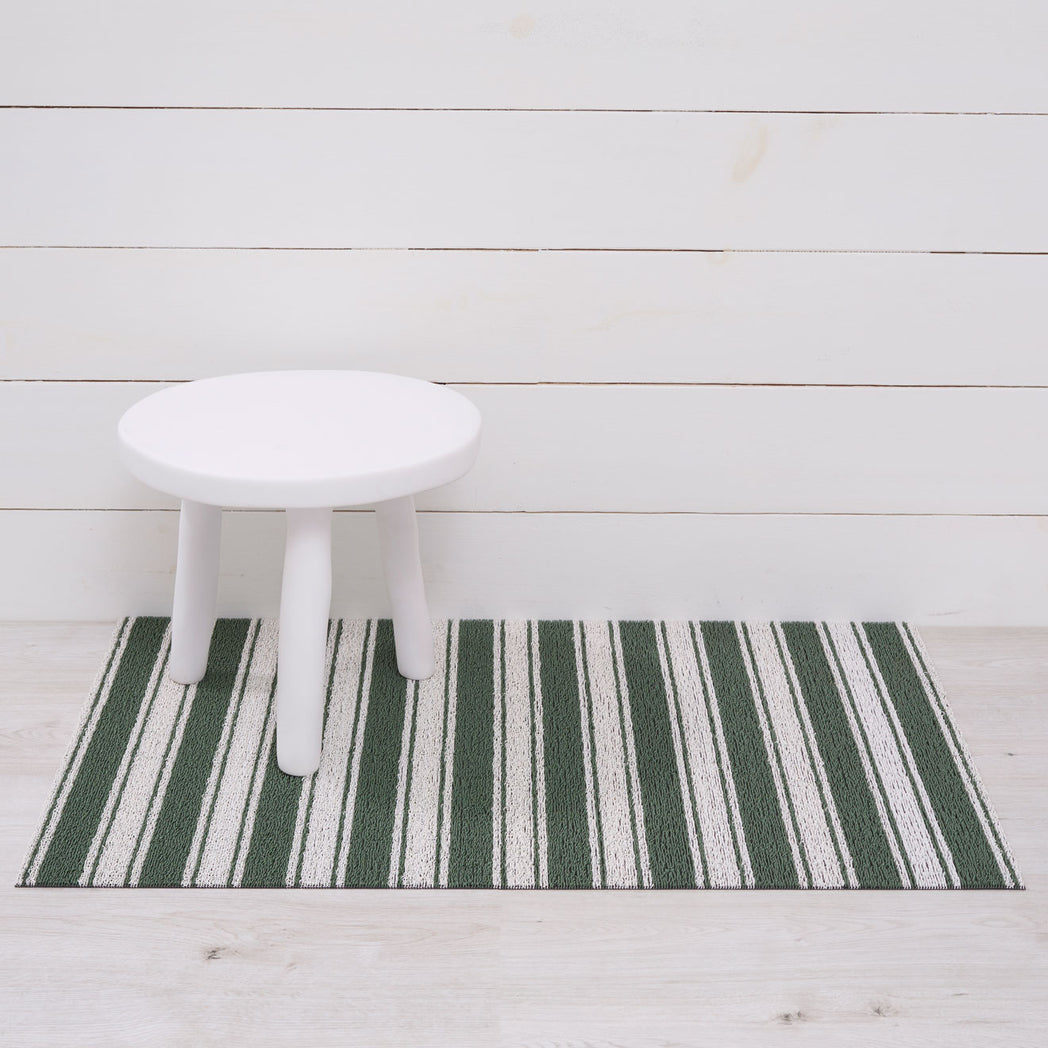 Chilewich striped woven mat with textured terrastrand yarn surface, featuring modern linear design and durable finish.