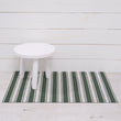 Chilewich striped woven mat with textured terrastrand yarn surface, featuring modern linear design and durable finish.