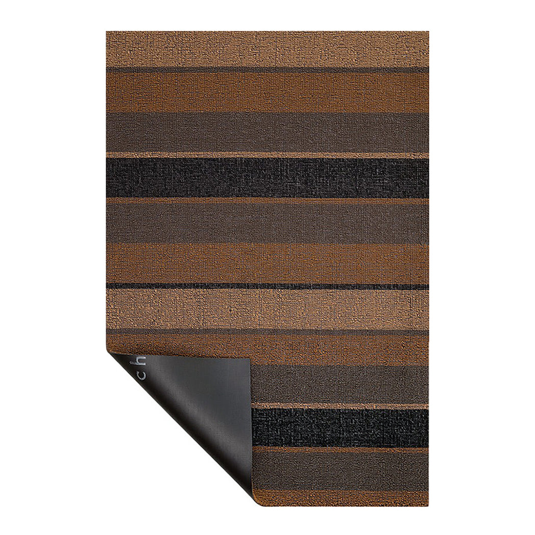 Chilewich striped woven mat with textured terrastrand yarn surface, featuring modern linear design and durable finish.