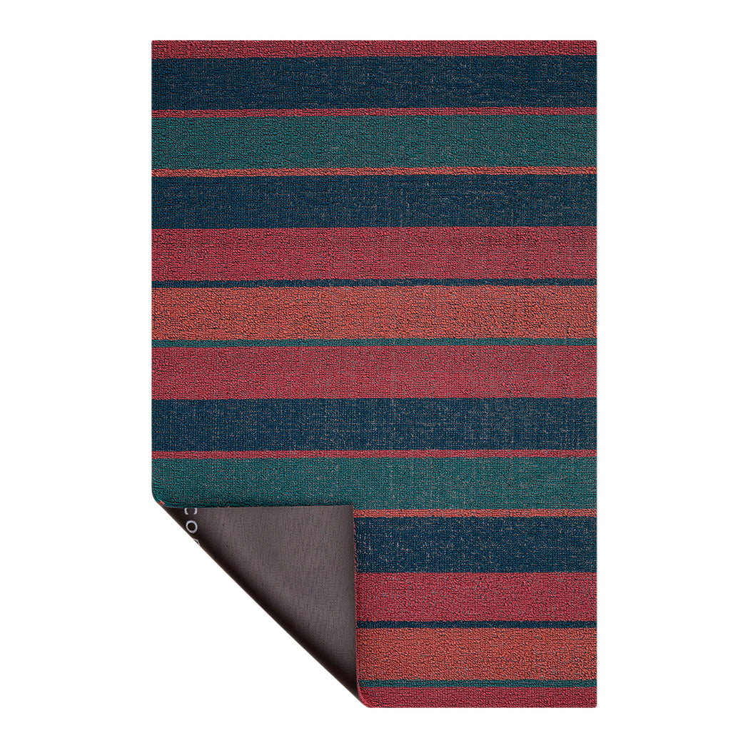 Chilewich striped woven mat with textured terrastrand yarn surface, featuring modern linear design and durable finish.