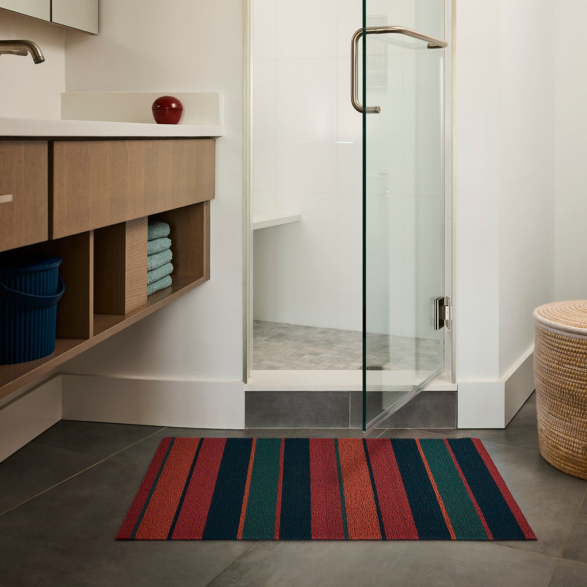 Chilewich striped woven mat with textured terrastrand yarn surface, featuring modern linear design and durable finish.