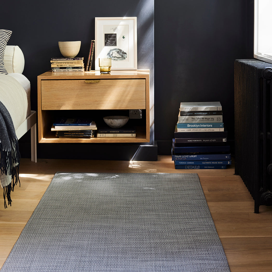 Chilewich Basketweave floor mat in Shadow, showcasing woven terrastrand yarn texture and modern design aesthetic.
