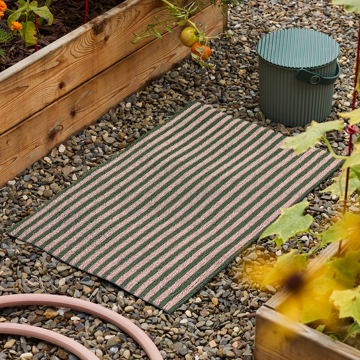 Chilewich striped woven mat with textured terrastrand yarn surface, featuring modern linear design and durable finish.