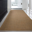 Chilewich Basketweave floor mat in Teak, showcasing woven terrastrand yarn texture and modern design aesthetic.