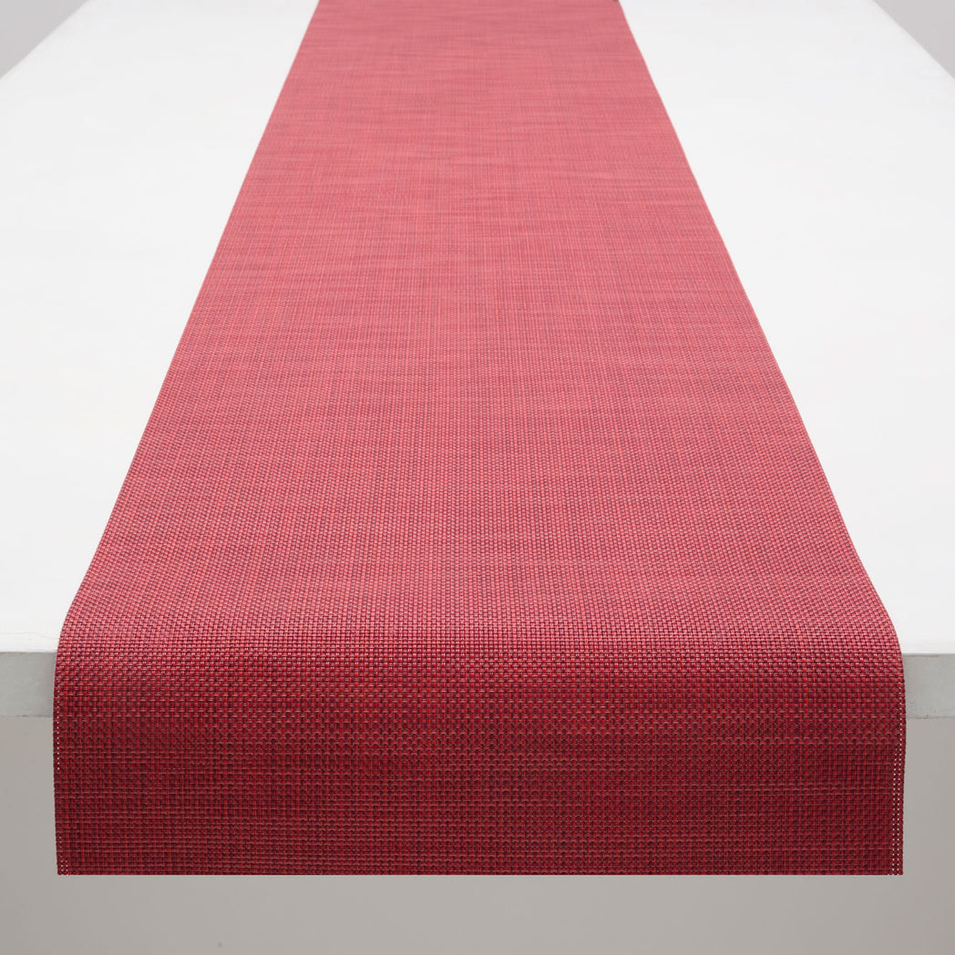 Chilewich Basketweave floor mat in Scarlet, showcasing woven terrastrand yarn texture and modern design aesthetic.