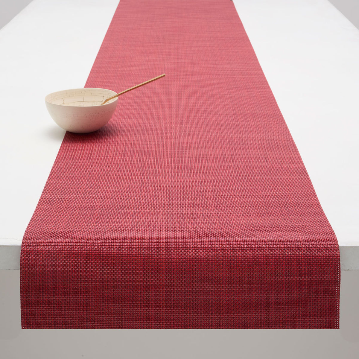 Chilewich Basketweave floor mat in Scarlet, showcasing woven terrastrand yarn texture and modern design aesthetic.