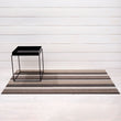 Chilewich striped woven mat with textured terrastrand yarn surface, featuring modern linear design and durable finish.
