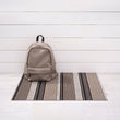 Chilewich striped woven mat with textured terrastrand yarn surface, featuring modern linear design and durable finish.