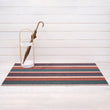 Chilewich striped woven mat with textured terrastrand yarn surface, featuring modern linear design and durable finish.
