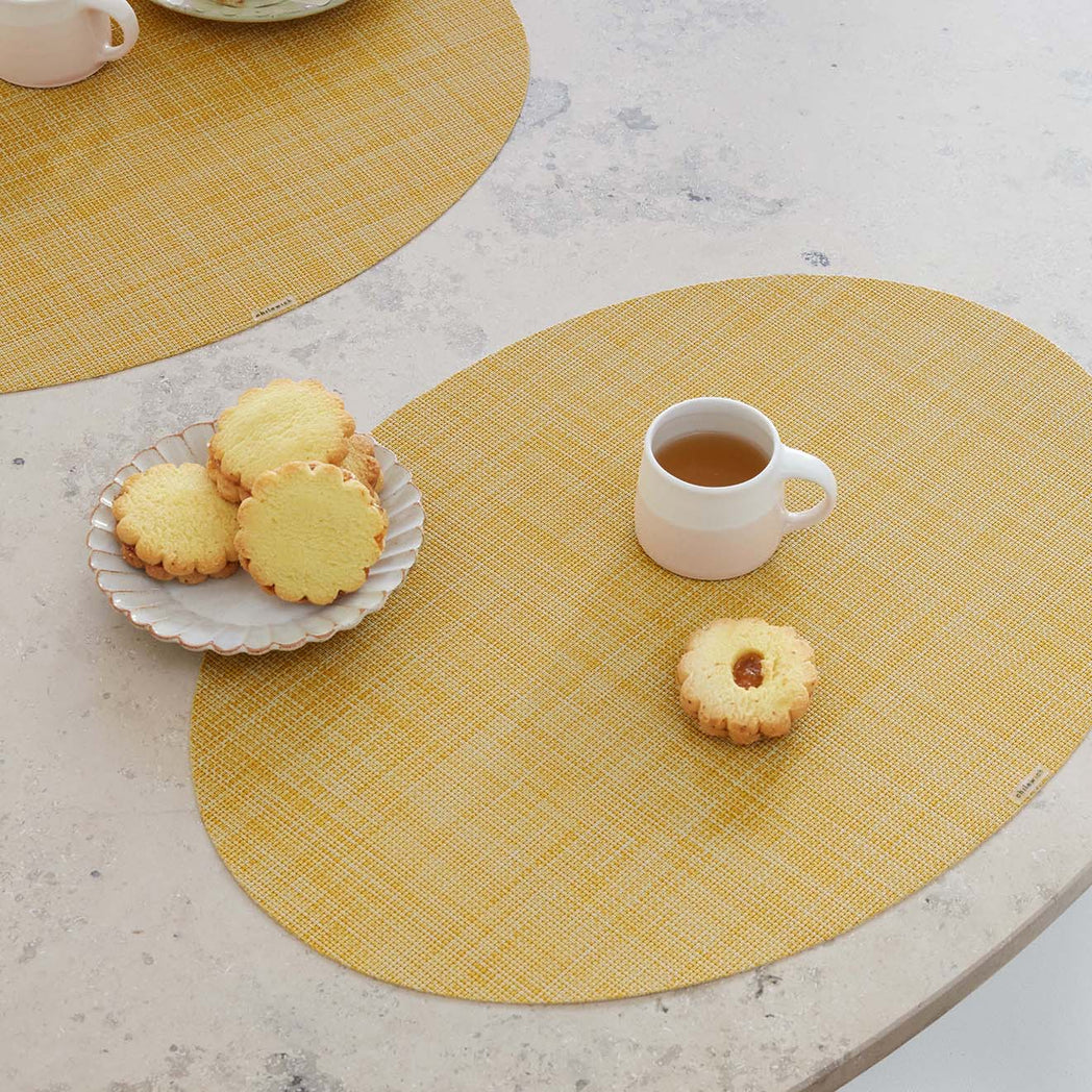 Chilewich Basketweave floor mat in Ochre, showcasing woven terrastrand yarn texture and modern design aesthetic.