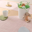 Chilewich Basketweave floor mat in egg, showcasing woven terrastrand yarn texture and modern design aesthetic.