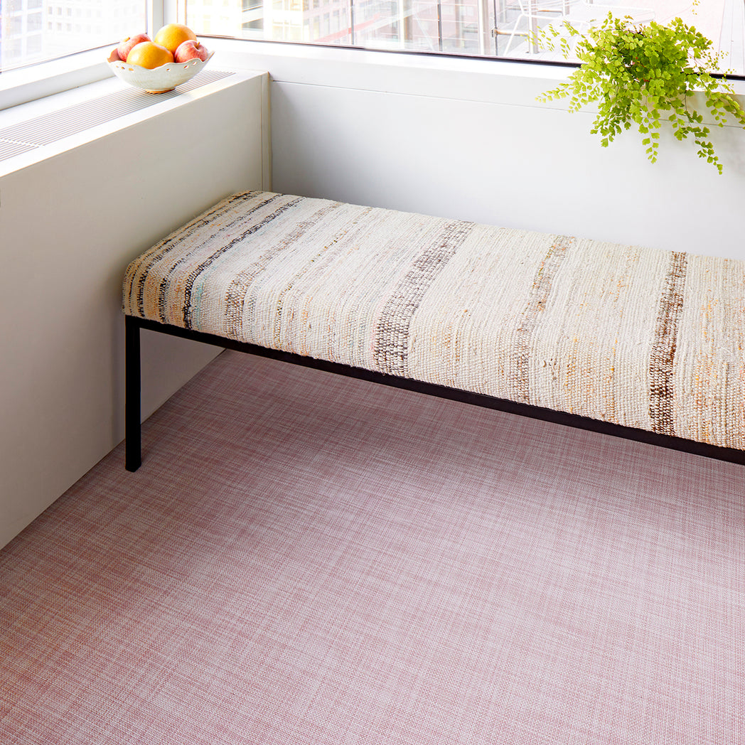 Chilewich Basketweave floor mat in blush, showcasing woven terrastrand yarn texture and modern design aesthetic.