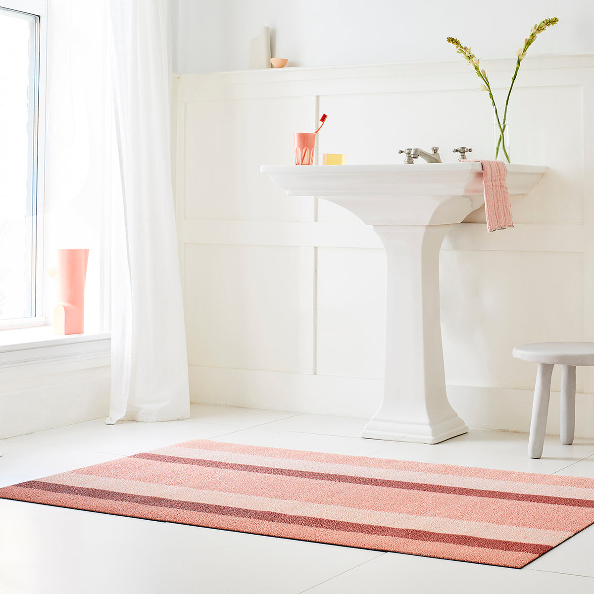 Chilewich striped woven mat with textured terrastrand yarn surface, featuring modern linear design and durable finish.