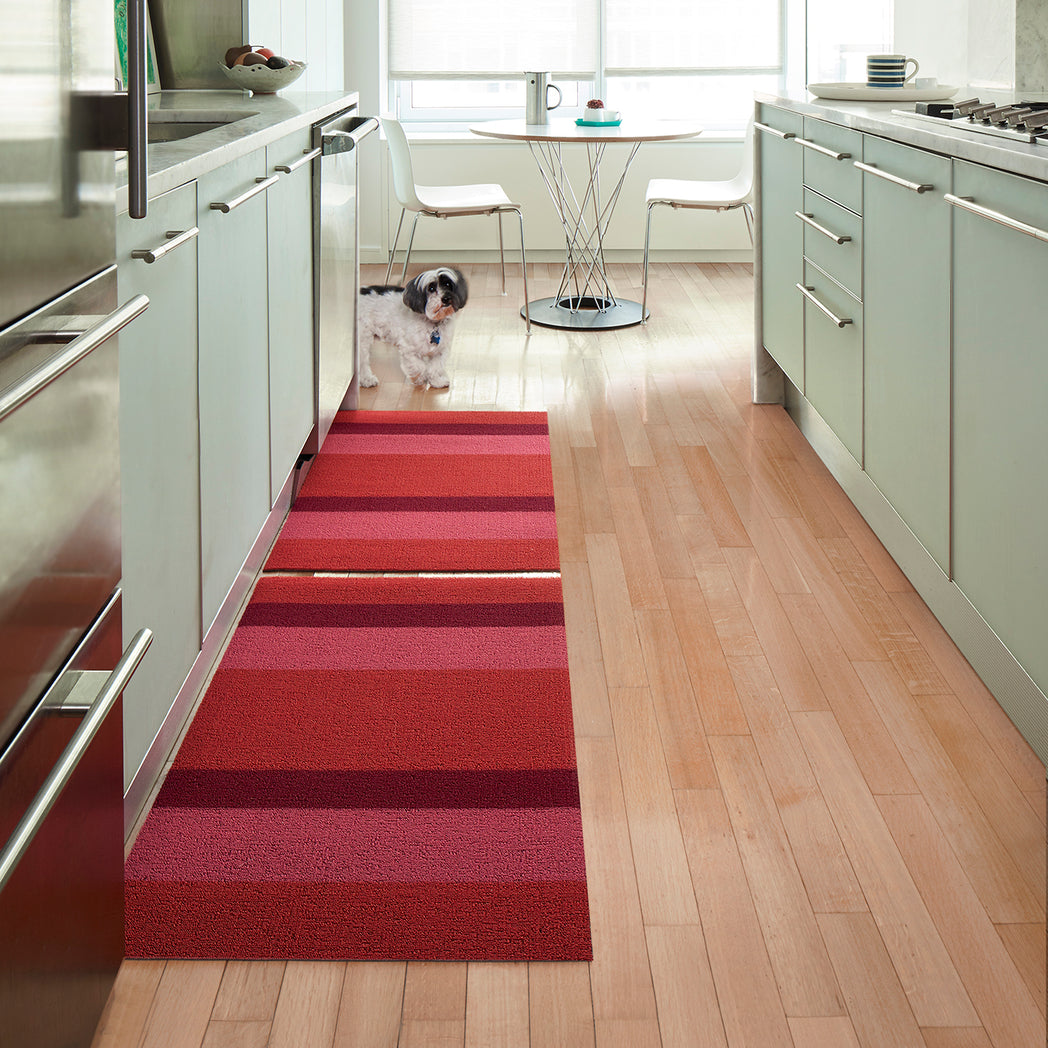 Chilewich striped woven mat with textured terrastrand yarn surface, featuring modern linear design and durable finish.