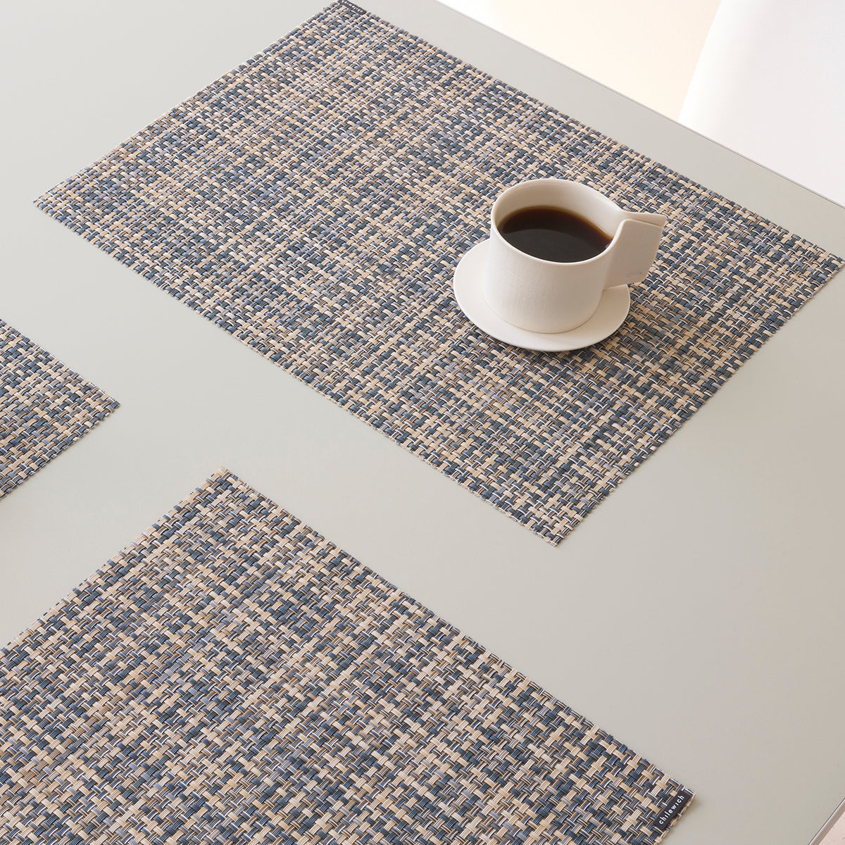Chilewich Basketweave floor mat in coast, showcasing woven terrastrand yarn texture and modern design aesthetic.