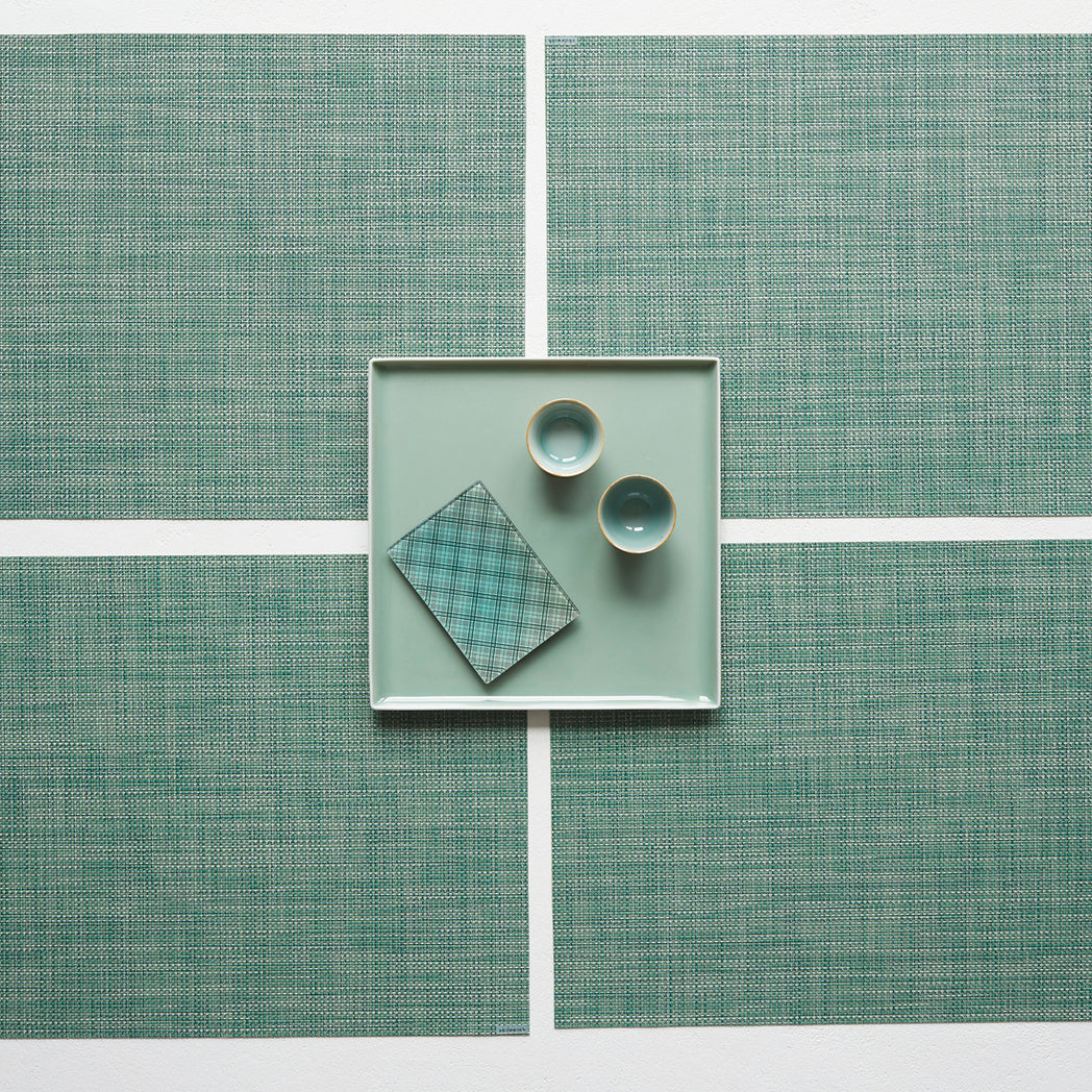 Chilewich Basketweave floor mat in ivy, showcasing woven terrastrand yarn texture and modern design aesthetic.