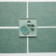 Chilewich Basketweave floor mat in ivy, showcasing woven terrastrand yarn texture and modern design aesthetic.