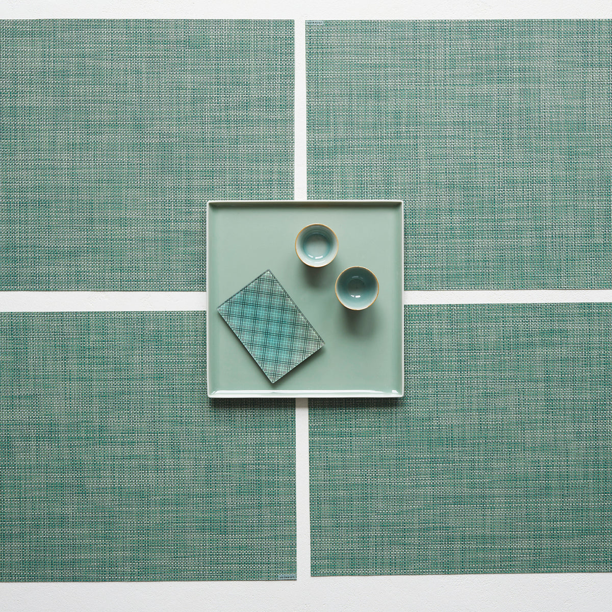 Chilewich Basketweave floor mat in ivy, showcasing woven terrastrand yarn texture and modern design aesthetic.