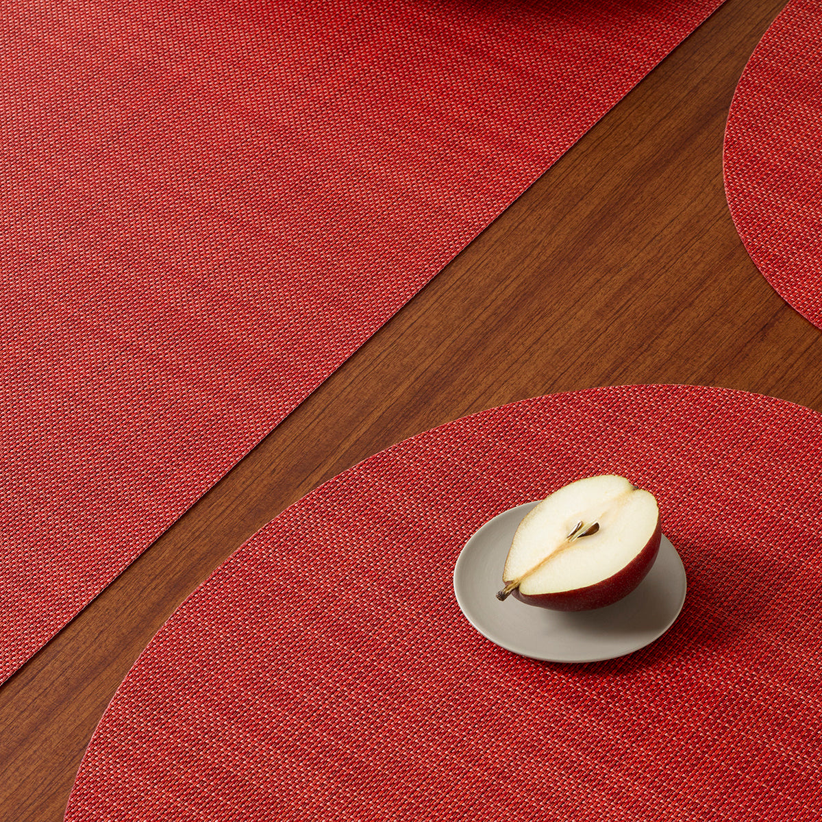Chilewich Basketweave floor mat in scarlet, showcasing woven terrastrand yarn texture and modern design aesthetic.